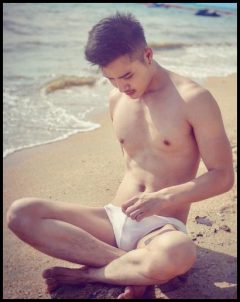 super sexy guy in white trunks on beach
